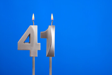 Birthday number 41 - Candle lit on blue background