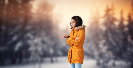 A young woman breathes air in the winter forest.