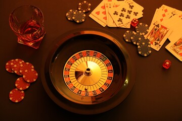 Roulette wheel, playing cards and chips on table, above view. Casino game - obrazy, fototapety, plakaty