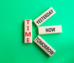 Time - Yesterday Now Tomorrow. Wooden cubes with words Time. Beautiful green background. Business and Time concept. Copy space.