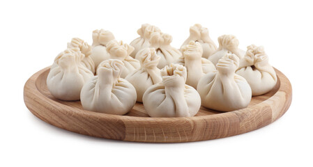 Wooden board with uncooked khinkali (dumplings) isolated on white. Georgian cuisine