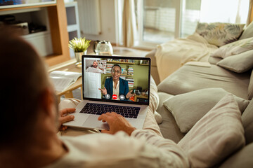 Man having video call with financial advisor from home