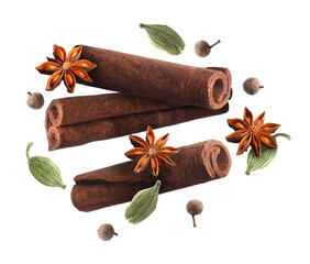 Cinnamon sticks and other aromatic spices falling on white background