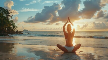 Fototapeta na wymiar woman practicing yoga on the beach at warm sunset light, back view