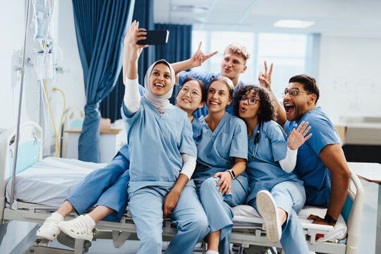 Group of nursing and medical students taking a celebratory selfie in a hospital