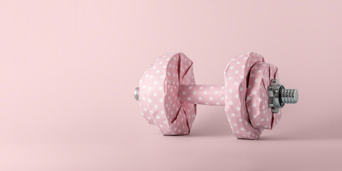 Fitness dumbbell wrapped in pink gift paper on pink pastel background with copy space. Creative...