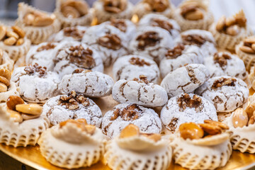 Horizontal photo assorted arabic nut pastries on ornate platter. Food and culture concept.