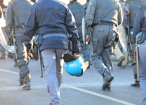 policemen in riot gear with protective helmet and truncheons during the protest demonstration in the city
