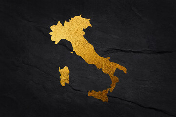 Italy shaped from golden glitter on a black background.