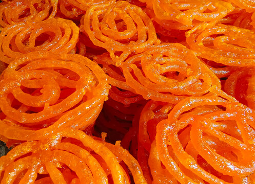 Hot Jalebi coated in sugar syrup, jalebi indian sweet.