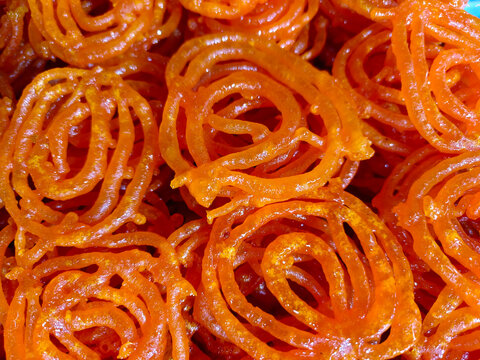 Hot Jalebi coated in sugar syrup, jalebi indian sweet.