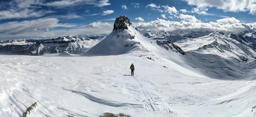 backcountry ski tour on the Spitzmeilen Wissmeilen. Young man fights his way to the summit in a...