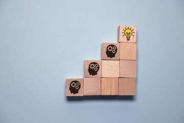 Concept creative idea and innovation. Hand picked wooden cube block with head human symbol and...