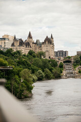 Fototapeta na wymiar Downtown Ottawa, Château Laurier and locks viewed from the bride over Ottawa river 