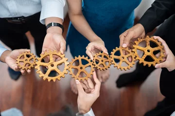 Fototapeten Office worker holding cog wheel as unity and teamwork in corporate workplace concept. Diverse colleague business people showing symbol of visionary system and mechanism for business success. Concord © Summit Art Creations