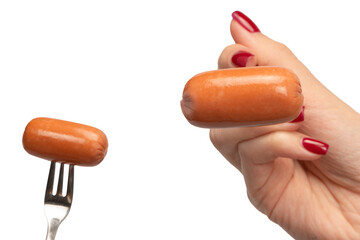 Small sausage on a fork in woman hand isolated.