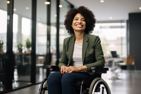 Portrait of disabled laughing confident wheelchair African American businesswoman in casual business outfit in modern office. Corporate career equal opportunities. Accessibility and inclusion concept