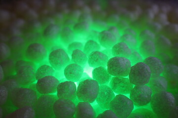 polystirene balls , green glowing  light background