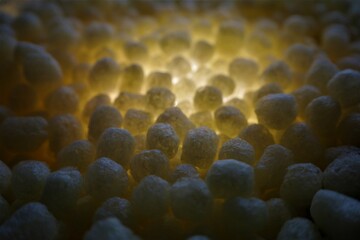 polystirene balls , yellow glowing light ,  textured  background