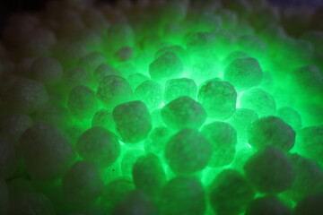 polystirene balls , green glowing  light background