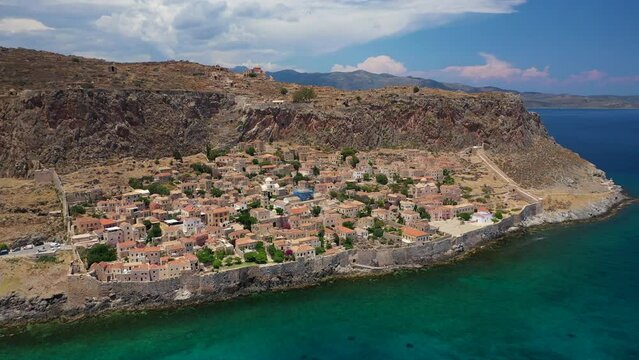 Aerial drone video of iconic medieval fortress of Monemvasia built on a rock of South East Peloponnese overlooking the Aegean sea, Greece