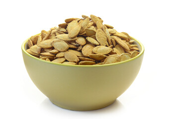 Bowl of salty pumpkin seeds isolated on white background