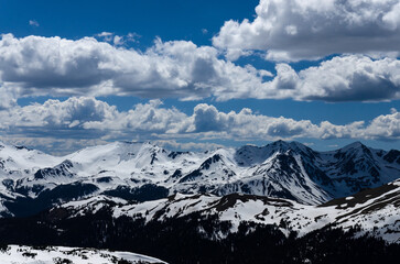 snow covered mountains and clouds