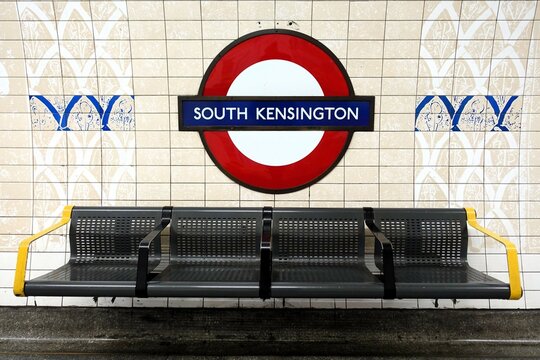 South Kensington station London Underground roundel sign and seating on the tube platform