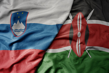 big waving national colorful flag of kenya and national flag of slovenia.