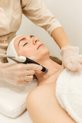 A cosmetologist performs hydropiling in a beauty salon. Skin care. High quality photo.
