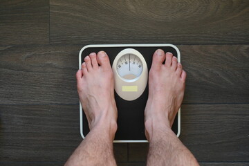 man feets on a weight scale , top view