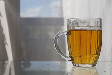 closeup pint of beer in  bright reflective background