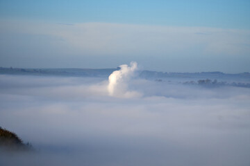 Steam rising through a cloud inversion at Darley Moor, Derbyshire, UK