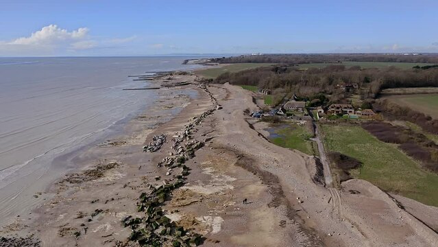 Atherington and Climping beach in West Sussex and the damaged sea defence and the temporary shingle bank in place to protect the land, aerial footage.