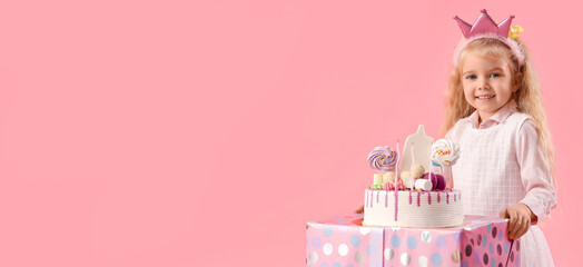 Cute little girl in crown with Birthday cake on pink background