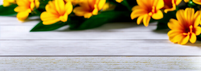 Nice background with out of focus flowers with yellow petals on a white wooden table.