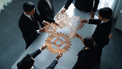 Top view of business people gather wooden cog together at meeting. Group of project manager helping...