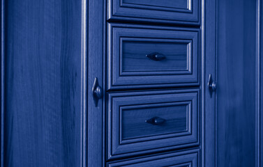 old style wooden chest of drawers background in blue
