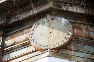 Clock with Roman numerals carved in stone on the outside of the Church of Nossa Senhora do Carmo in São João Del Rei.