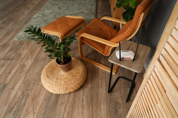 Interior of modern living room with armchair and wi-fi router on table