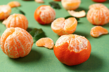 Fresh tangerines on green background