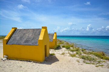 Ochre yellow stone slave huts in Bonaire island.
