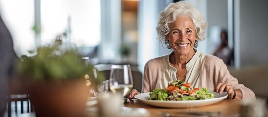 old woman and salad dish or vegetable food on the table