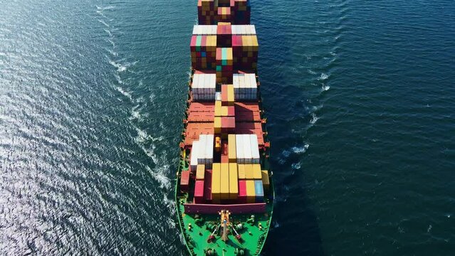Container ship cruising to cargo port for logistics import export, aerial view