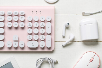Composition with different modern gadgets on white wooden background, closeup