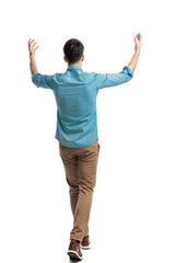 rear view of casual man stepping and celebrating