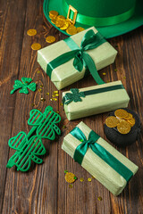 Gift boxes with leprechaun hat, pot of golden coins and plastic eyeglasses for St. Patrick's Day...