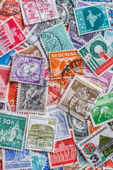 Postage stamps.A collection of world stamps in a pile.Postage stamps from different countries and...