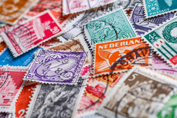 Postage stamps.A collection of world stamps in a pile.Postage stamps from different countries and times