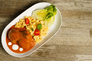 Chicken with paprika sauce, noodles with egg and vegetables